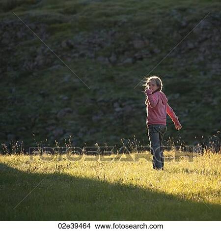 Girl in sunlit meadow View Large Photo Image Picture - Girl in sunlit meadow. Fotosearch