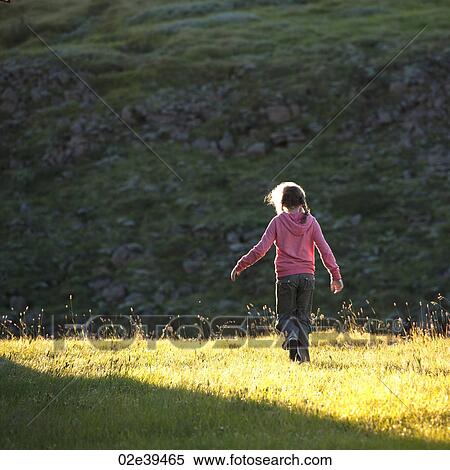 Girl in sunlit meadow View Large Photo Image Stock Photography - Girl in sunlit meadow. Fotosearch