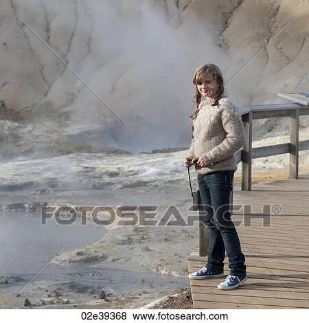 Girl on boardwalk next to geothermal geyser vents View Large Photo Image Stock Photo - Girl on boardwalk next to geothermal geyser vents. Fotosearch
