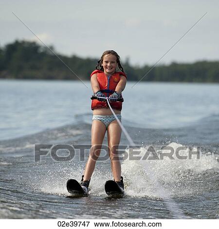 Girl on waterskis at Lake of the Woods, Ontario View Large Photo Image Stock Photo - Girl on waterskis at Lake of the Woods, Ontario. Fotosearch