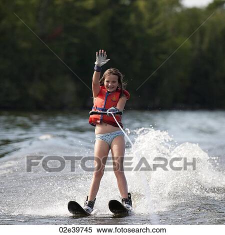 Stock Photography - Girl on waterskis at Lake of the Woods, Ontario. Fotosearch