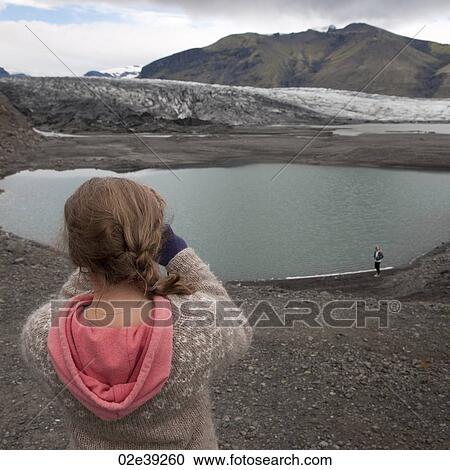 Girl photgrapher taking picture of glacial lake View Large Photo Image Stock Image - Girl photgrapher taking picture of glacial lake. Fotosearch