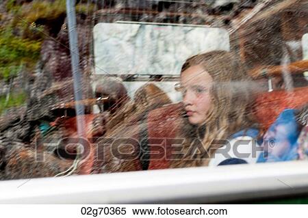 Girl sitting at a window on a tour bus, Norway View Large Photo Image Stock Photography - Girl sitting at a window on a tour bus, Norway. Fotosearch
