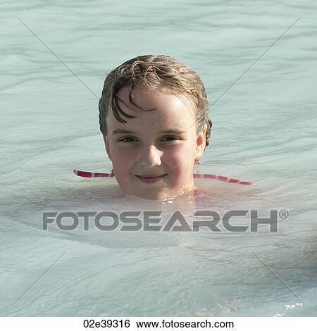 Stock Photograph - Girl swimming in mineral pool. Fotosearch