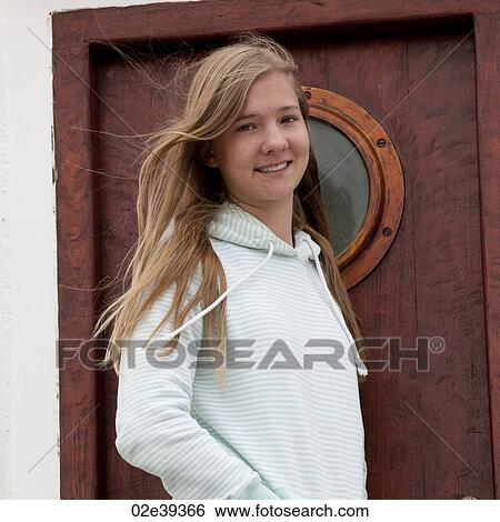 Girl with long windy hair before door with porthole View Large Photo Image Stock Photograph - Girl with long windy hair before door with porthole. Fotosearch
