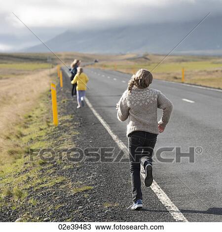 Girls running away alongside the highway in the countryside View Large Photo Image Stock Image - Girls running away alongside the highway in the countryside. Fotosearch
