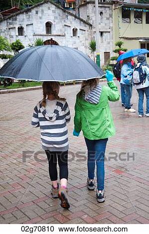 Girls sheltering under an umbrella, Peru View Large Photo Image Stock Image - Girls sheltering under an umbrella, Peru. Fotosearch