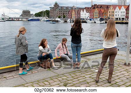 Girls taking picture of a city, Bryggen, Bergen, Norway View Large Photo Image Stock Image - Girls taking picture of a city, Bryggen, Bergen, Norway. Fotosearch