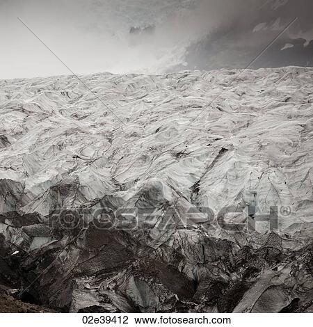 Glacier ice field in misty mountain valley View Large Photo Image Stock Image - Glacier ice field in misty mountain valley. Fotosearch