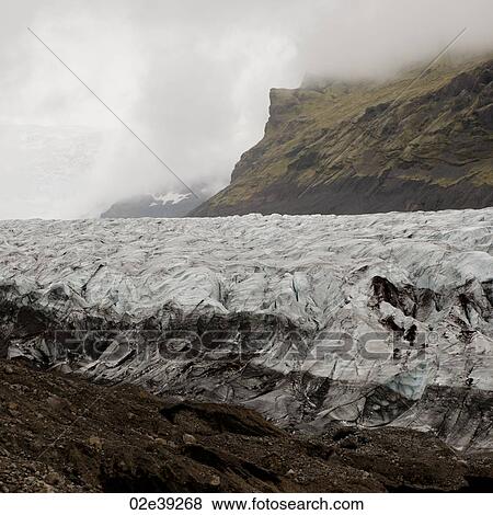 Glacier in cloudy mountain valley View Large Photo Image Stock Photo - Glacier in cloudy mountain valley. Fotosearch