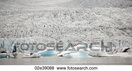 Glacier meeting the ocean and icebergs floating View Large Photo Image Stock Photo - Glacier meeting the ocean and icebergs floating. Fotosearch