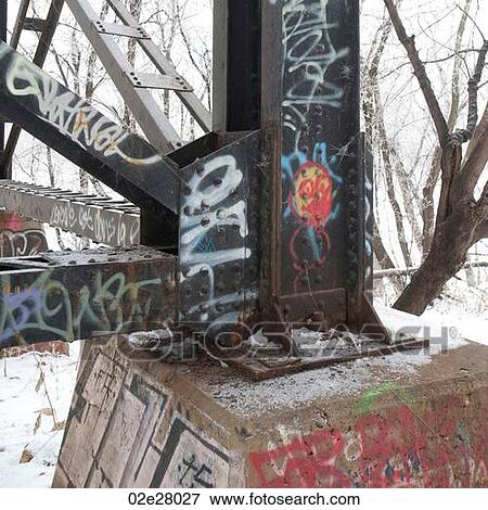 Stock Photo - Graffiti on steel post with snow. Fotosearch