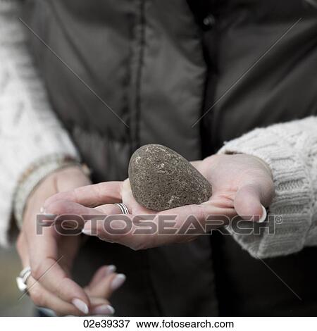 Hand holding smooth rock View Large Photo Image Stock Photo - Hand holding smooth rock. Fotosearch