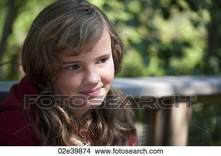Head shot of a young girl with the sunlight on her face View Large Photo Image Picture - Head shot of a young girl with the sunlight on her face. Fotosearch