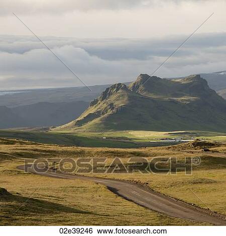 Highway disappearing towards mountains through grasslands of Iceland View Large Photo Image Stock Photograph - Highway disappearing towards mountains through grasslands of Iceland. Fotosearch