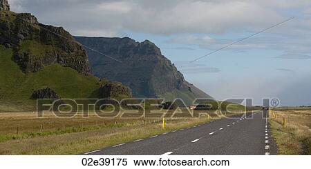 Highway vanishing through farmland beside mountain View Large Photo Image Stock Photography - Highway vanishing through farmland beside mountain. Fotosearch