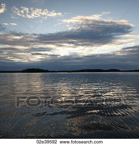 Stock Image - Horizon at dusk in Lake of the Woods, Ontario. Fotosearch
