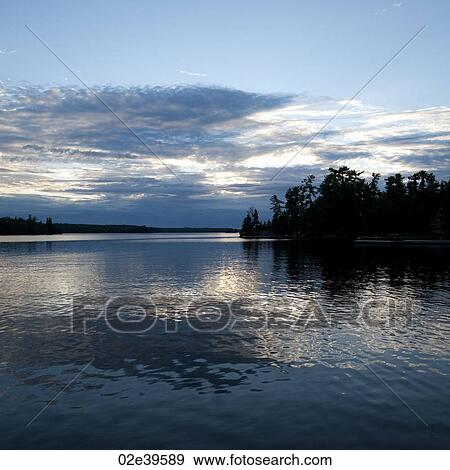 Stock Photo - Horizon at dusk in Lake of the Woods, Ontario. Fotosearch