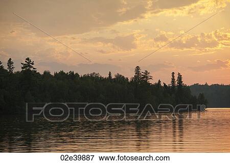 Stock Photo - Horizon at sunset in Lake of the Woods, Ontario. Fotosearch