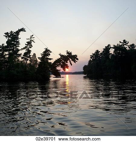 Stock Image - Horizon sky at dusk in Lake of the Woods, Ontario. Fotosearch