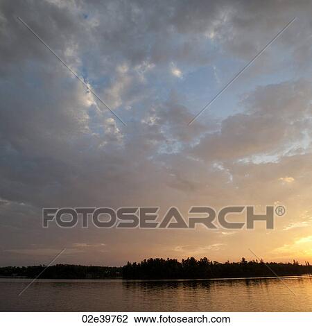 Stock Image - Horizon sky at dusk in Lake of the Woods, Ontario. Fotosearch