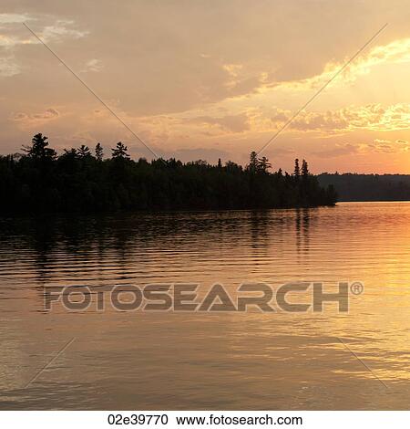 Stock Image - Horizon sky at dusk in Lake of the Woods, Ontario. Fotosearch