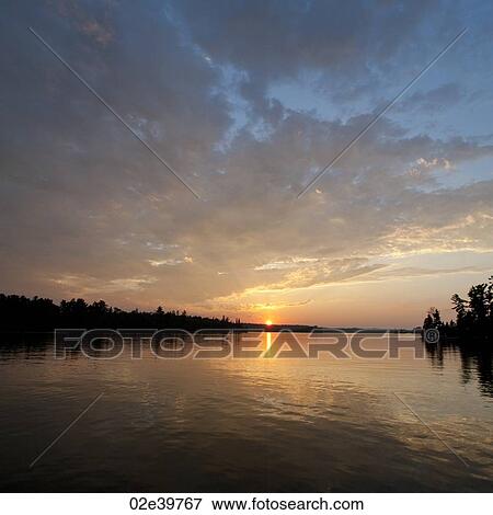 Stock Photo - Horizon sky at dusk in Lake of the Woods, Ontario. Fotosearch