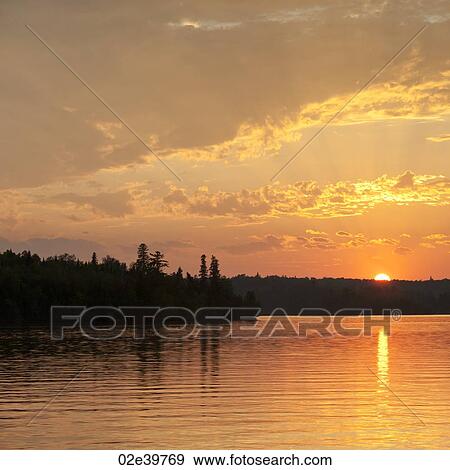 Stock Photo - Horizon sky at dusk in Lake of the Woods, Ontario. Fotosearch