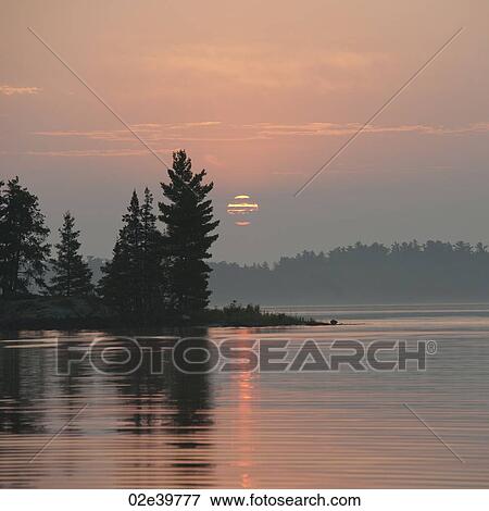 Stock Photo - Horizon sky at sunset in Lake of the Woods, Ontario. Fotosearch