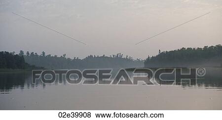 Stock Photo - Horizon sky at twilight in Lake of the Woods, Ontario. Fotosearch