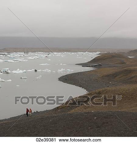 Icebergs floating along glacial lakeshore View Large Photo Image Stock Image - Icebergs floating along glacial lakeshore. Fotosearch