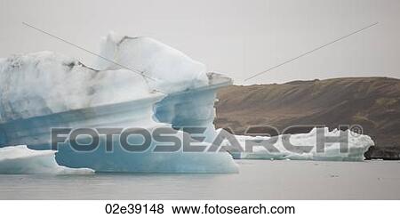 Icebergs floating in the ocean View Large Photo Image Stock Photo - Icebergs floating in the ocean. Fotosearch