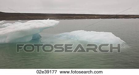 Icebergs floating in the ocean View Large Photo Image Stock Photo - Icebergs floating in the ocean. Fotosearch