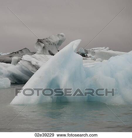 Icebergs floating in the ocean View Large Photo Image Stock Photo - Icebergs floating in the ocean. Fotosearch
