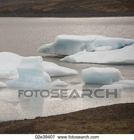 Icebergs floating offshore in a glacial lake View Large Photo Image Stock Photo - Icebergs floating offshore in a glacial lake. Fotosearch