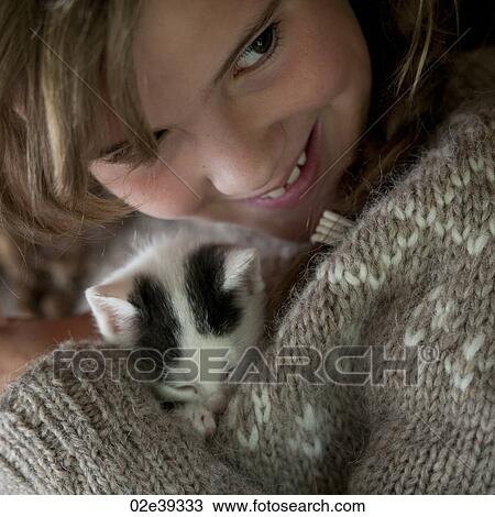 Kitten cuddled by girl View Large Photo Image Stock Image - Kitten cuddled by girl. Fotosearch