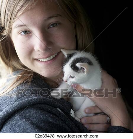 Kitten cuddled by girl View Large Photo Image Stock Photo - Kitten cuddled by girl. Fotosearch
