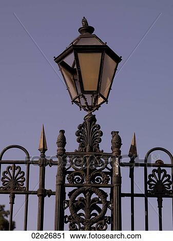 Stock Image - Lamp on iron fence in Naples. Fotosearch