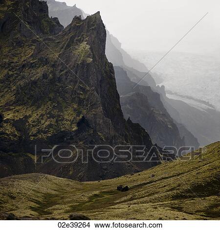Landscape, craggy mountain valley overlooking glacier field View Large Photo Image Picture - Landscape, craggy mountain valley overlooking glacier field. Fotosearch