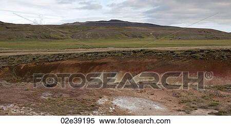 Landscape, eroded mineral rich gully through grassland, before grassy mountains View Large Photo Image Stock Photography - Landscape, eroded mineral rich gully through grassland, before grassy mountains. Fotosearch