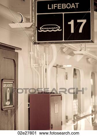 Stock Image - Lifeboat sign on cruise ship. Fotosearch