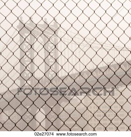 Manhattan Bridge through a chain link fence in Manhattan, New York City, U. S. A. View Large Photo Image Picture - Manhattan Bridge through a chain link fence in Manhattan, New York City, U. S. A.. Fotosearch