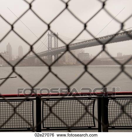 Manhattan Bridge through a chain link fence in Manhattan, New York City, U. S. A. View Large Photo Image Stock Photograph - Manhattan Bridge through a chain link fence in Manhattan, New York City, U. S. A.. Fotosearch