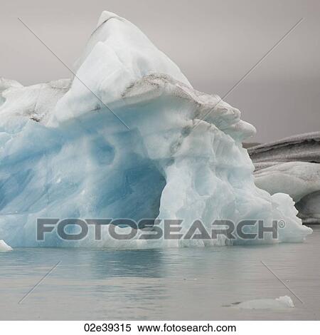 Melting iceberg in glacial lake, with an ice cave View Large Photo Image Stock Photography - Melting iceberg in glacial lake, with an ice cave. Fotosearch