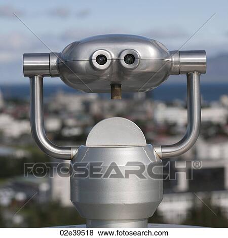 Metalic binocular viewer above city skyline View Large Photo Image Stock Photo - Metalic binocular viewer above city skyline. Fotosearch