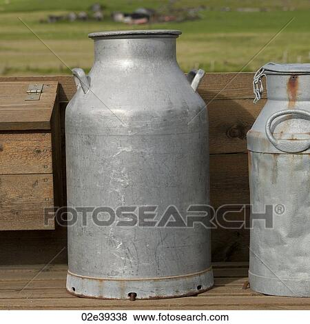 Milk can on wooden deck in countryside View Large Photo Image Stock Photo - Milk can on wooden deck in countryside. Fotosearch