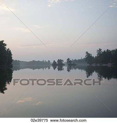Misty sky over Lake of the Woods, Ontario View Large Photo Image Stock Photography - Misty sky over Lake of the Woods, Ontario. Fotosearch