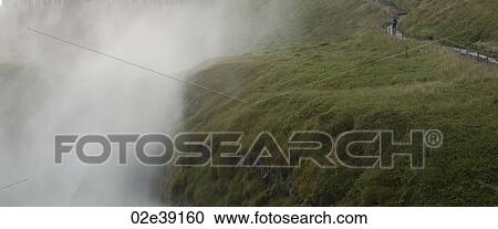 Misty valley beside verdant hiking trail View Large Photo Image Stock Image - Misty valley beside verdant hiking trail. Fotosearch