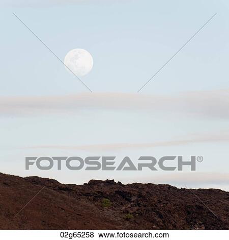 Moon in the sky, Bartolome island, Galapagos Islands, Ecuador View Large Photo Image Stock Photo - Moon in the sky, Bartolome island, Galapagos Islands, Ecuador. Fotosearch