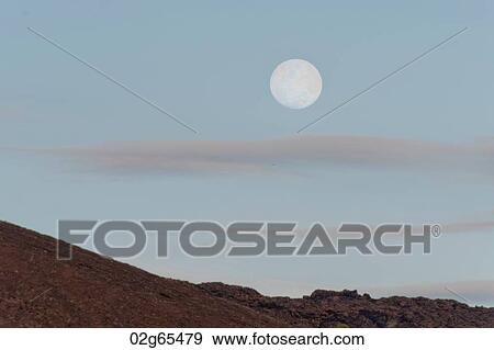 Moon in the sky, Bartolome island, Galapagos Islands, Ecuador View Large Photo Image Stock Photo - Moon in the sky, Bartolome island, Galapagos Islands, Ecuador. Fotosearch